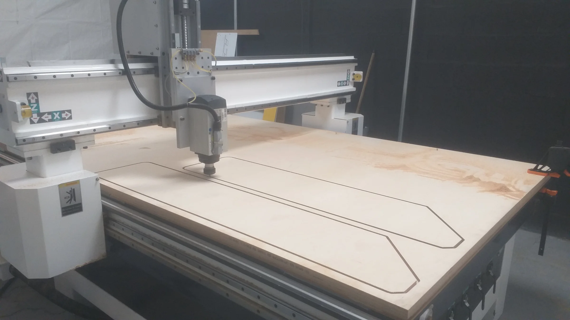 Fraiseuse CNC grand format usinant un panneau de bois dans l’atelier Concept Numeric